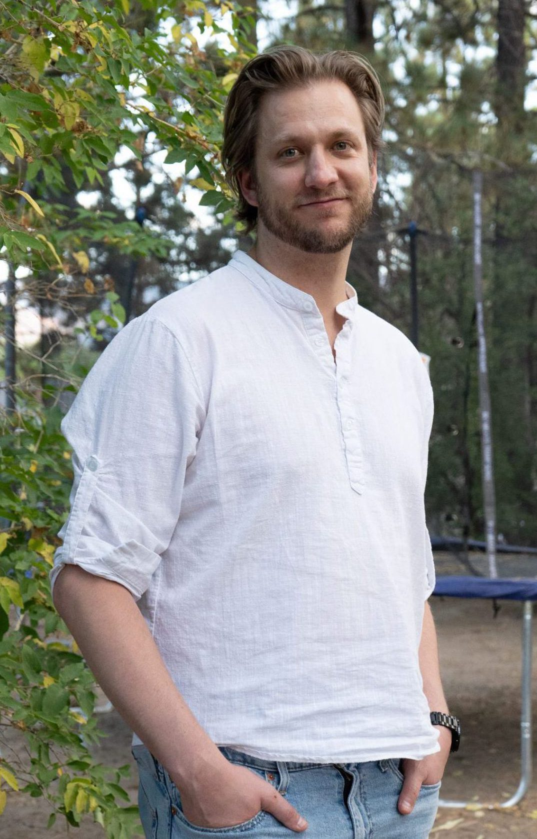 Travis posing confidently in casual outfit