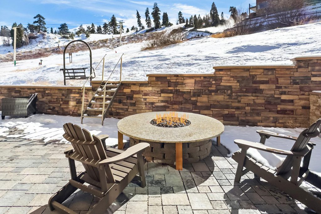 A welcoming porch with comfortable seating, offering a beautiful view of the surrounding nature in a tranquil mountain setting.