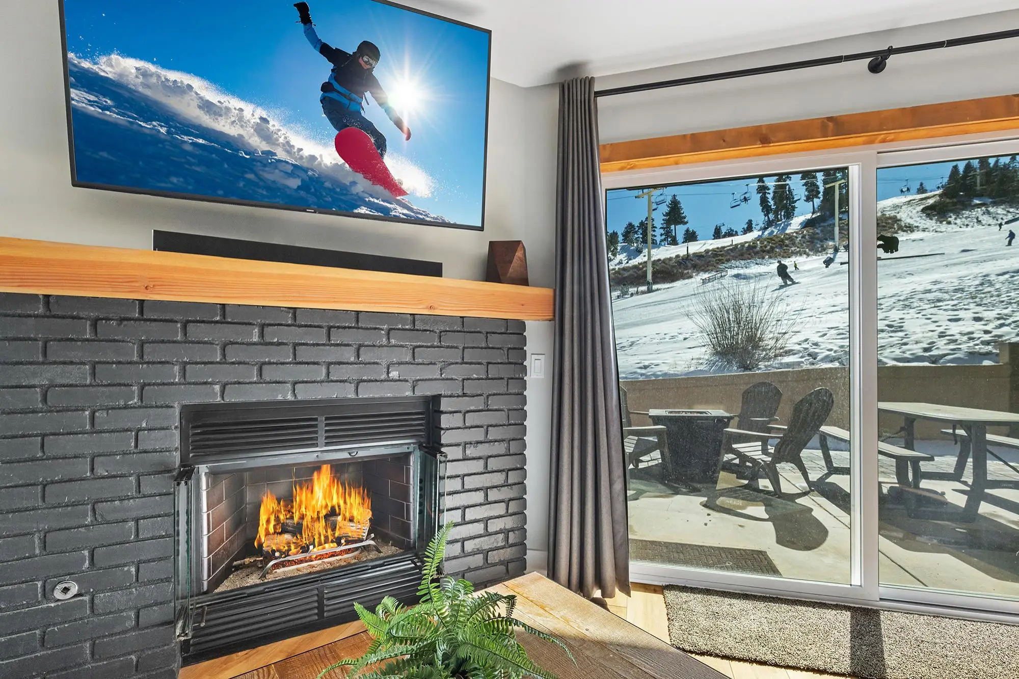 Cozy Big Bear living room with fireplace and window view of ski slopes