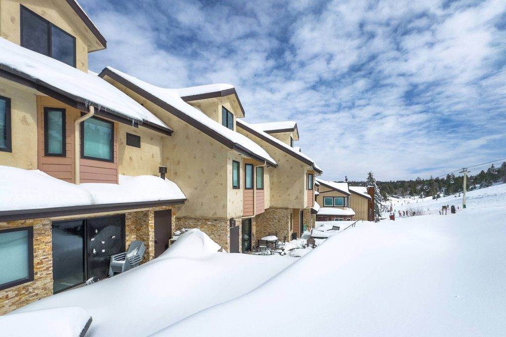 Side view of Comstock Condos in winter overlooking Bear Mountain ski area