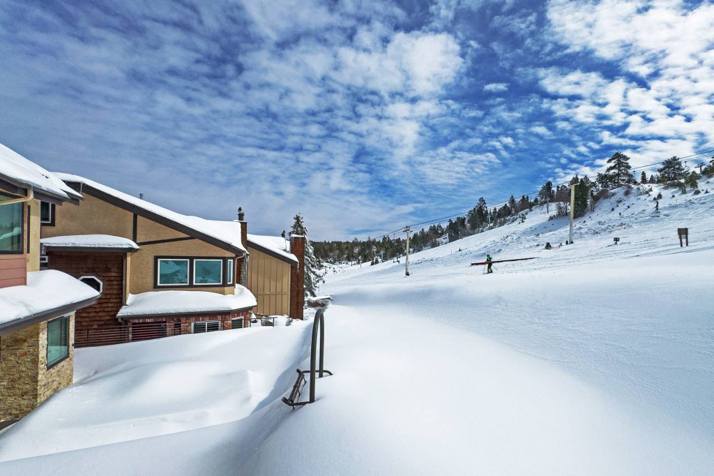 Exterior walkway between snow-covered Comstock condos in Big Bear