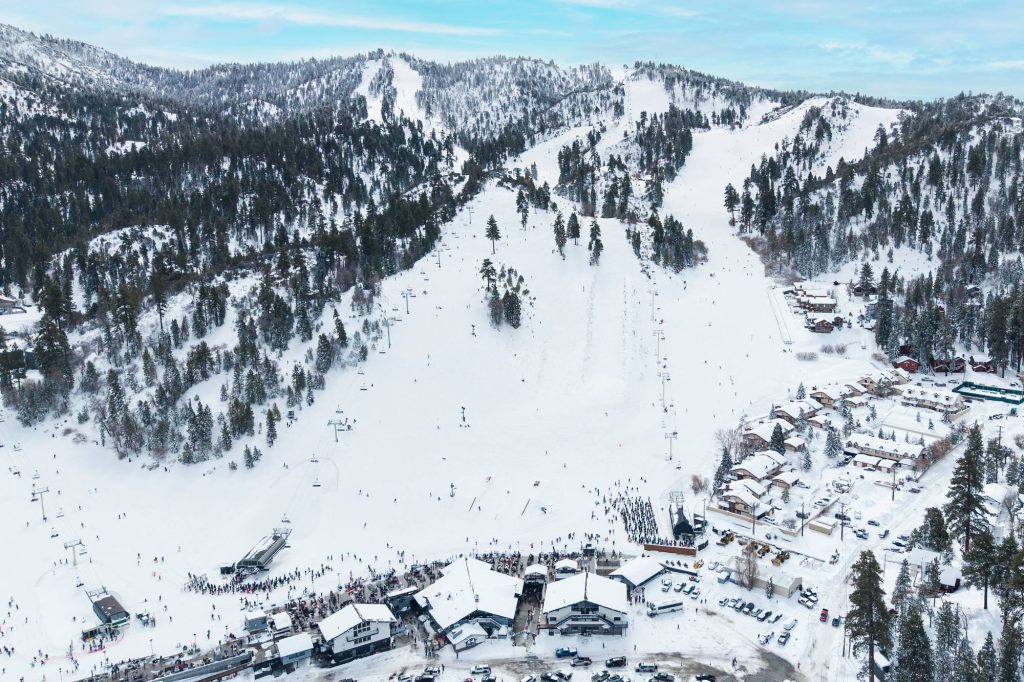 Wide drone view of Bear Mountain ski resort with chairlifts and snow-covered runs