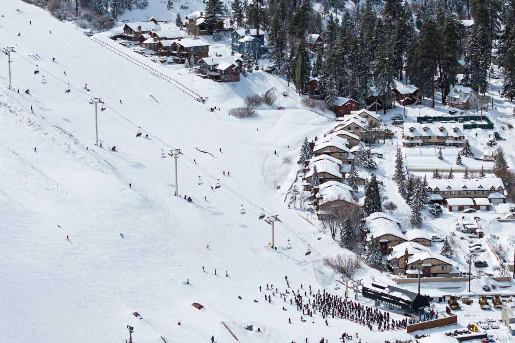 Skiers riding chairlift above Bear Mountain slopes near Comstock condos