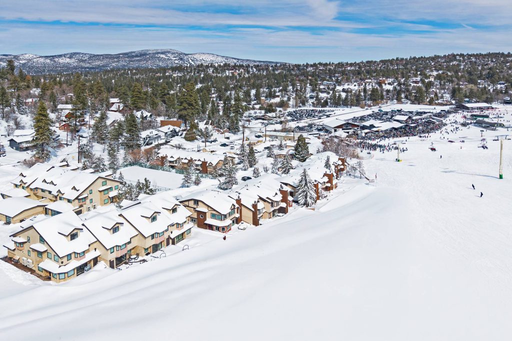Snow-covered Comstock Highlands condos along Bear Mountain ski run