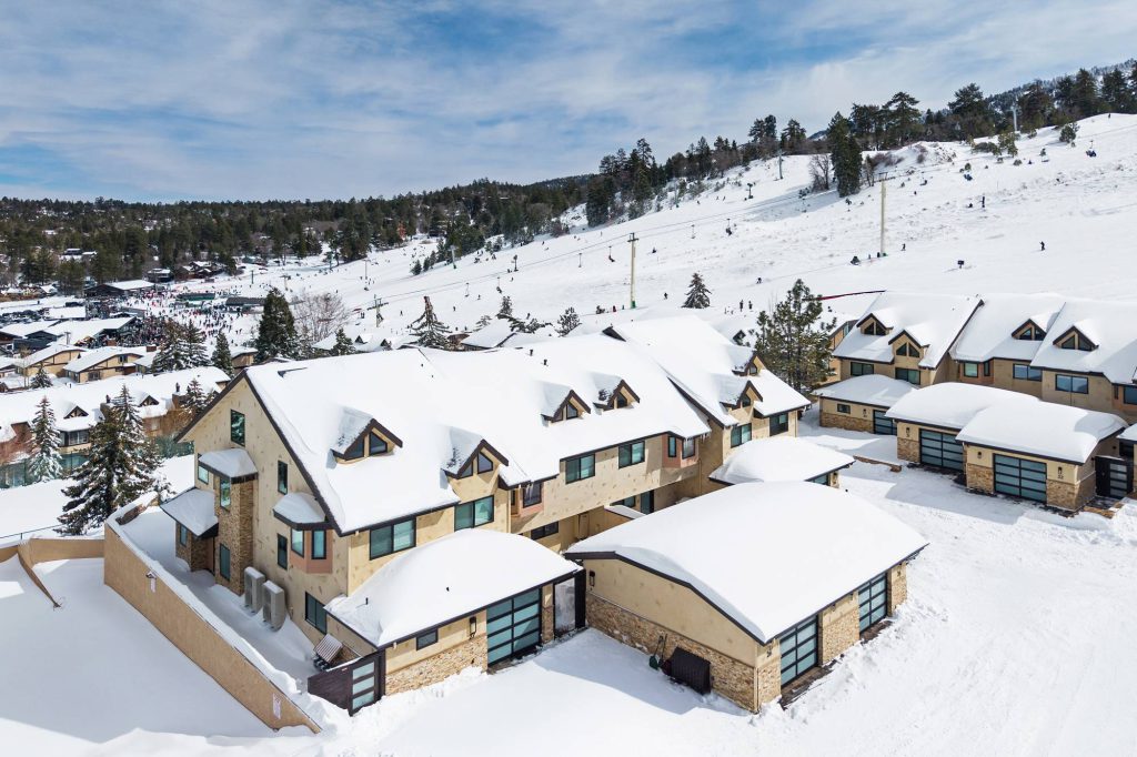 Modern Comstock Highlands townhomes with snow-covered garages near Bear Mountain