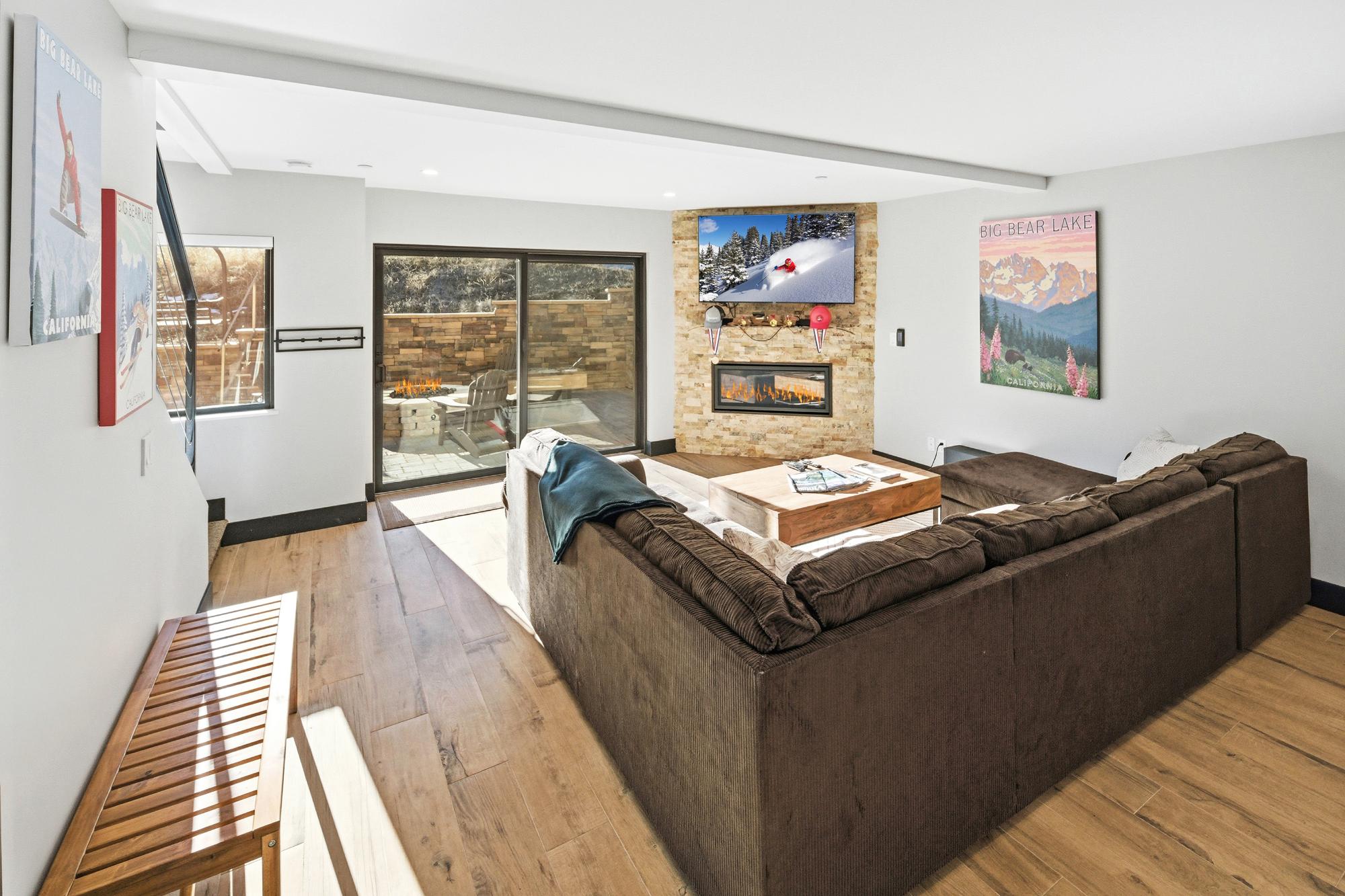 Modern living room at Bear Mountain Dropzone with fireplace, large sectional sofa, and Big Bear Lake decor